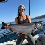 Robyn, a former online student, holding a giant salmon.